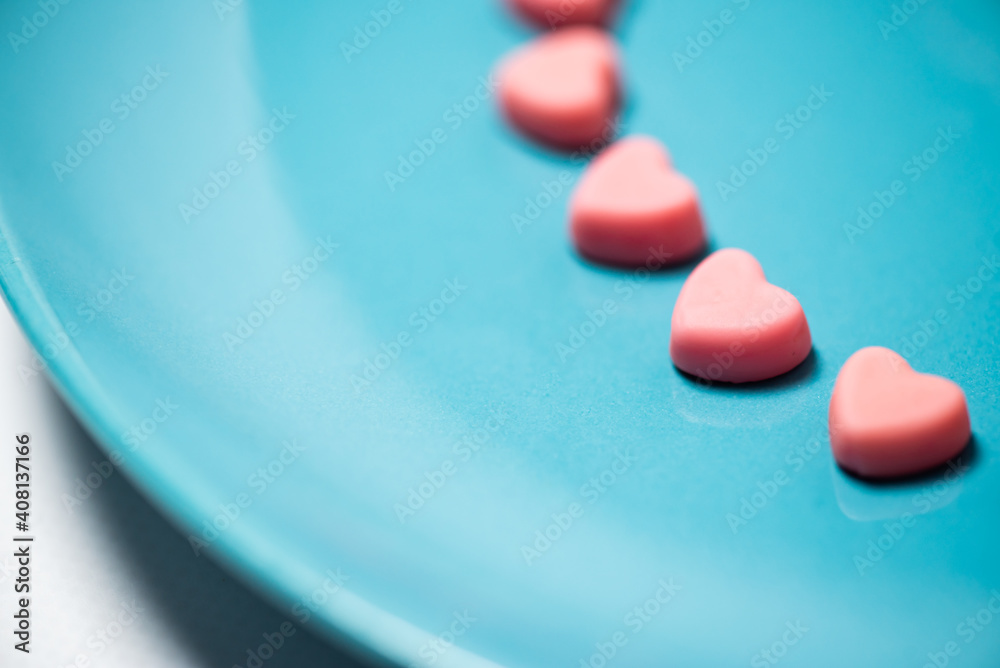Pink hearts on a blue pastel background. Valentine```s day concept Pink hearts on a blue pastel background. Valentine```s day concept