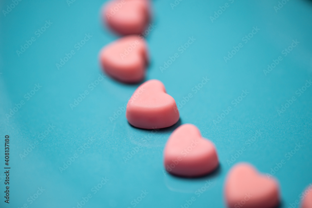 Pink hearts on a blue pastel background. Valentine```s day concept Pink hearts on a blue pastel background. Valentine```s day concept