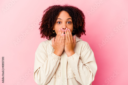 Young african american mixed race woman isolated shocked  covering mouth with hands  anxious to discover something new.