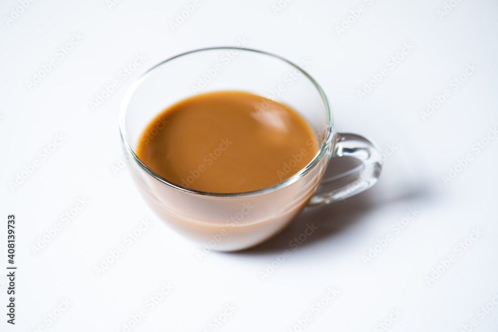 Clear glass of milk coffee on white background
