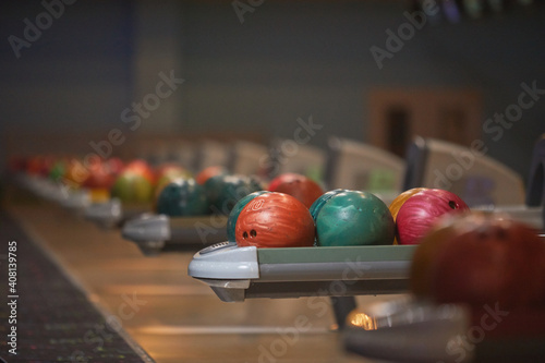 Graphic background image of ball return machines and bowling ball in row at entertainment center  copy space