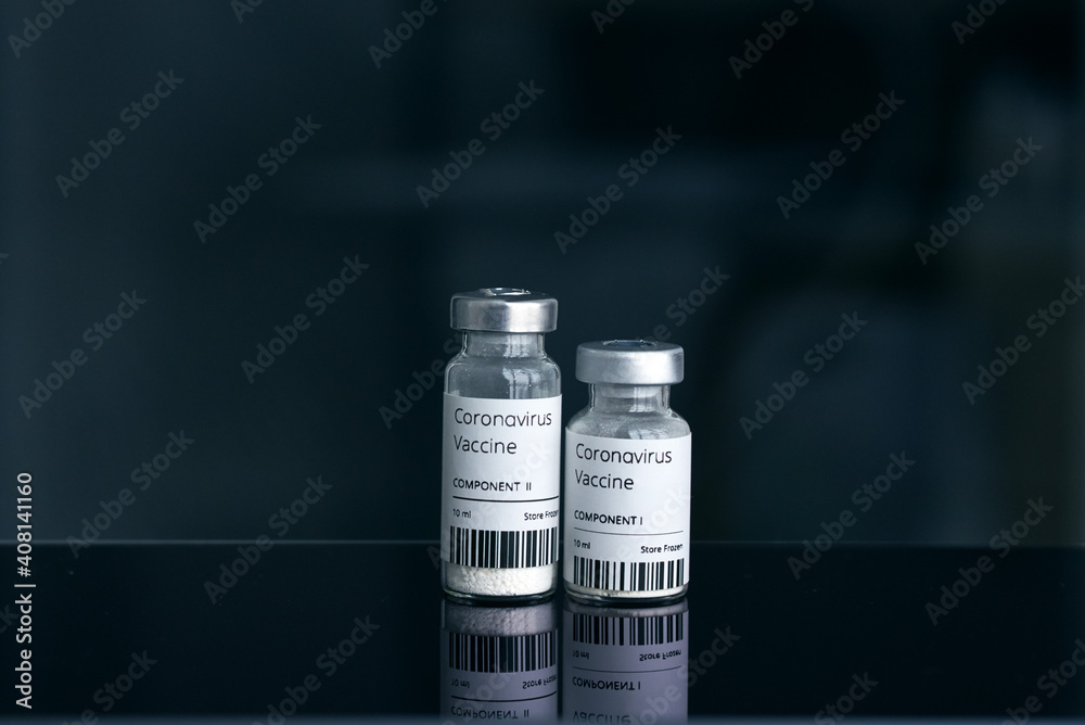 Coronavirus vaccine two small ampoules with two-component vaccine stand on a dark mirror table Coronavirus vaccine two small ampoules with two-component vaccine stand on a dark mirror table