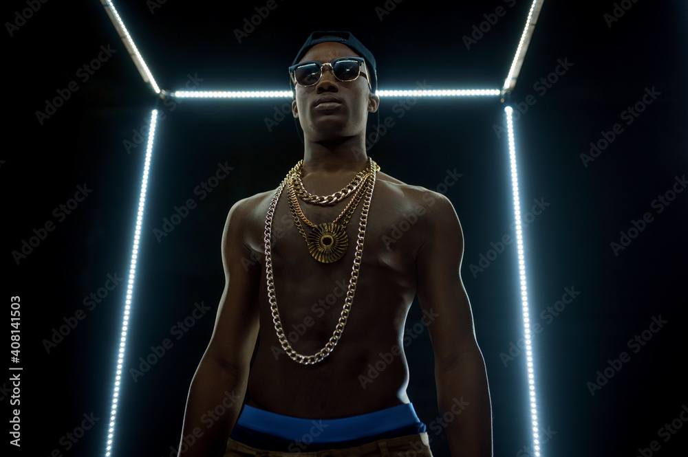 Serious rapper in gold chains, bottom view - obrazy, fototapety, plakaty 