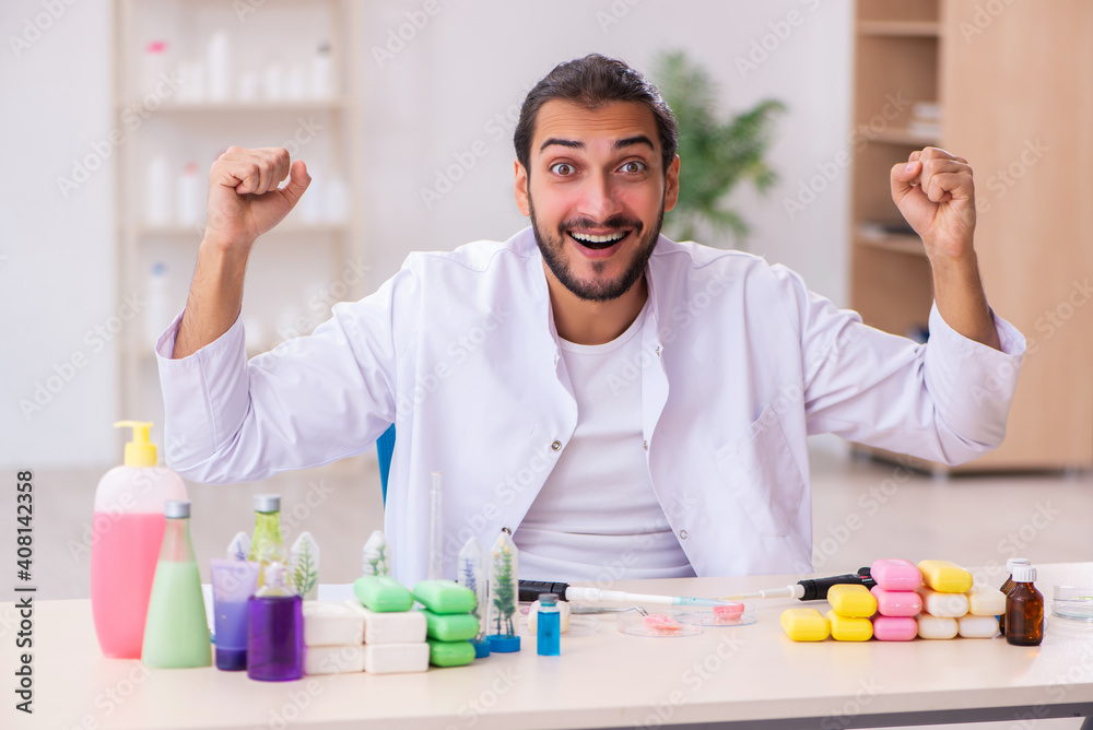 Young male chemist testing soap in the lab Young male chemist testing soap in the lab