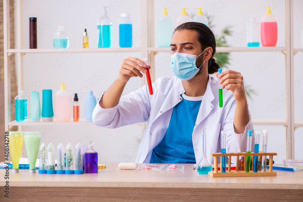 Young male chemist testing soap in the lab Young male chemist testing soap in the lab