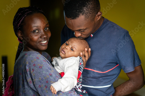 Young black family happy mom and dad holding a baby