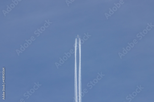 condensation trail of a plane in the blue sky