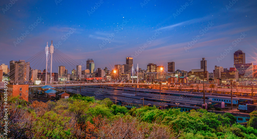 Naklejka premium Nelson Mandela Bridge and Johannesburg city lit up at night