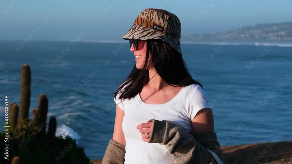 beautiful happiness young woman girl latin portrait with bucket hat on the beach,sunset, pichilemu, punta de lobos. Chilean Latina. Outdoors beautiful happiness young woman girl latin portrait with bucket hat on the beach,sunset, pichilemu, punta de lobos. Chilean Latina. Outdoors