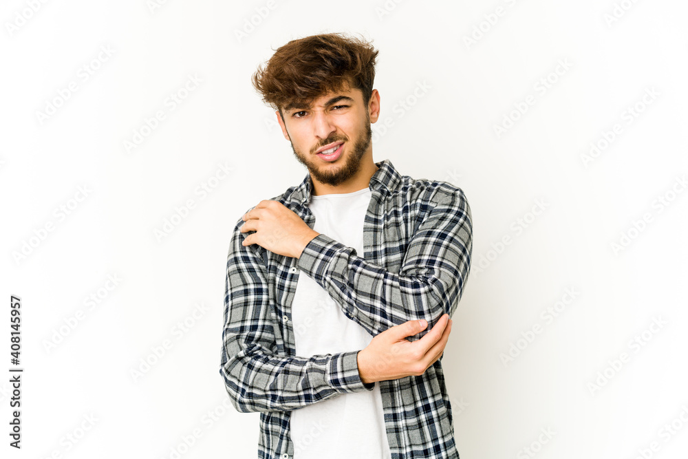 Young arab man on white background massaging elbow, suffering after a bad movement. Young arab man on white background massaging elbow, suffering after a bad movement.