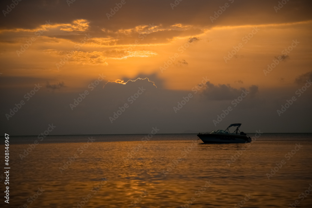 beautiful sunset at sea. speed boat in the rays of the evening sun beautiful sunset at sea. speed boat in the rays of the evening sun