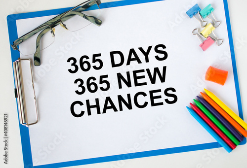 A clipboard with text 365 days 365 new chances eyeglasses paper clips