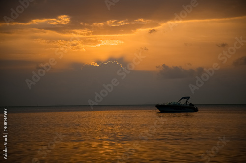 beautiful sunset at sea. speed boat in the rays of the evening sun