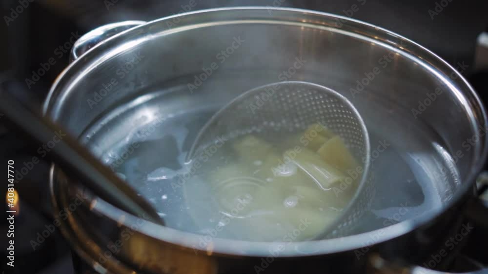 Steamy Cooked Rigatoni Pasta In A Pot With Strainer Spoon Ladle. - Close Up Shot Steamy Cooked Rigatoni Pasta In A Pot With Strainer Spoon Ladle. - Close Up Shot