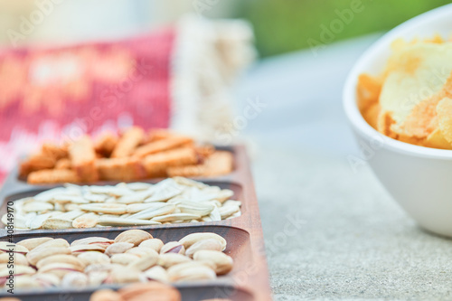 Assorted snacks and a bowl of chips on white table