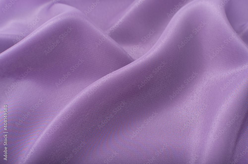 A piece of purple cloth. Fabric texture for background and design works of art, beautiful wrinkled pattern of silk or linen