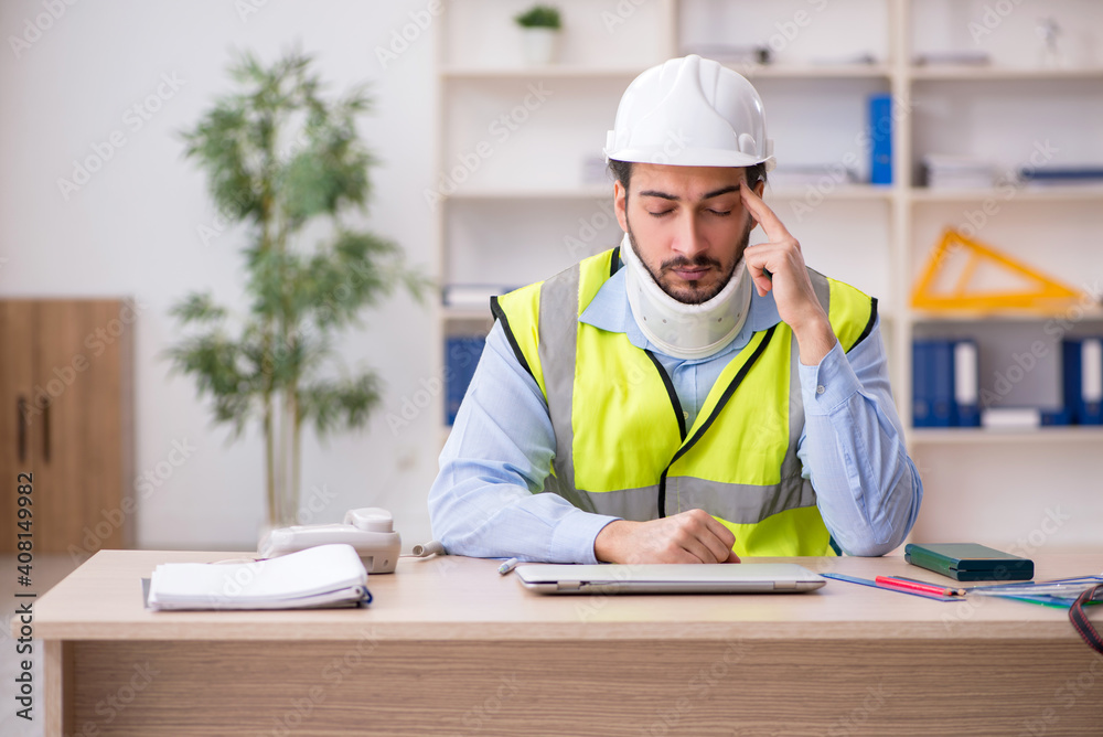Young neck injured male architect in safety concept Young neck injured male architect in safety concept