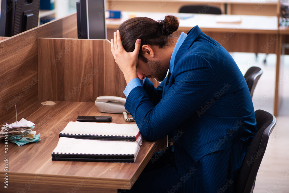 Fototapeta premium Young male employee working in the office