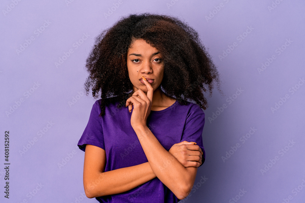 Young african american curly woman isolated on purple background unhappy looking in camera with sarcastic expression. Young african american curly woman isolated on purple background unhappy looking in camera with sarcastic expression.