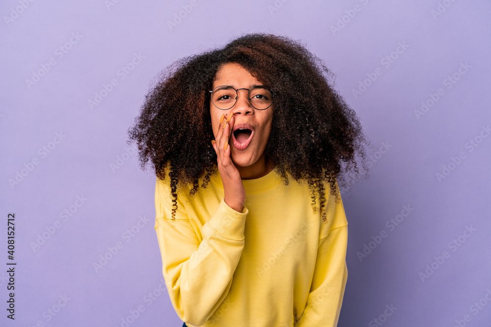 Young african american curly woman isolated on purple background is saying a secret hot braking news and looking aside Young african american curly woman isolated on purple background is saying a secret hot braking news and looking aside
