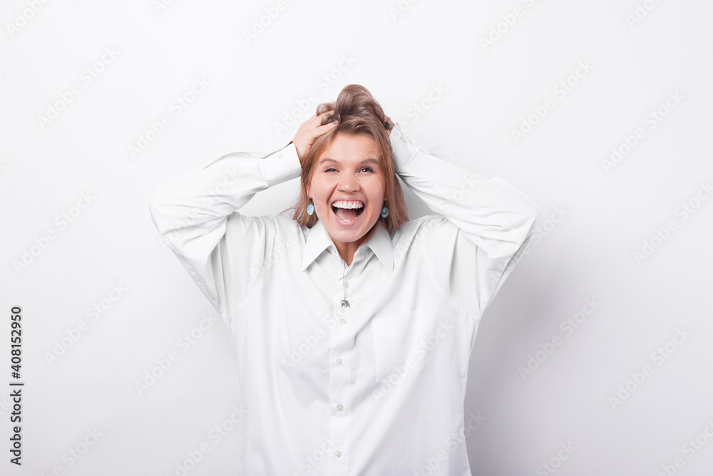 Photo of surprised young woman in white shirt over white background. Photo of surprised young woman in white shirt over white background.