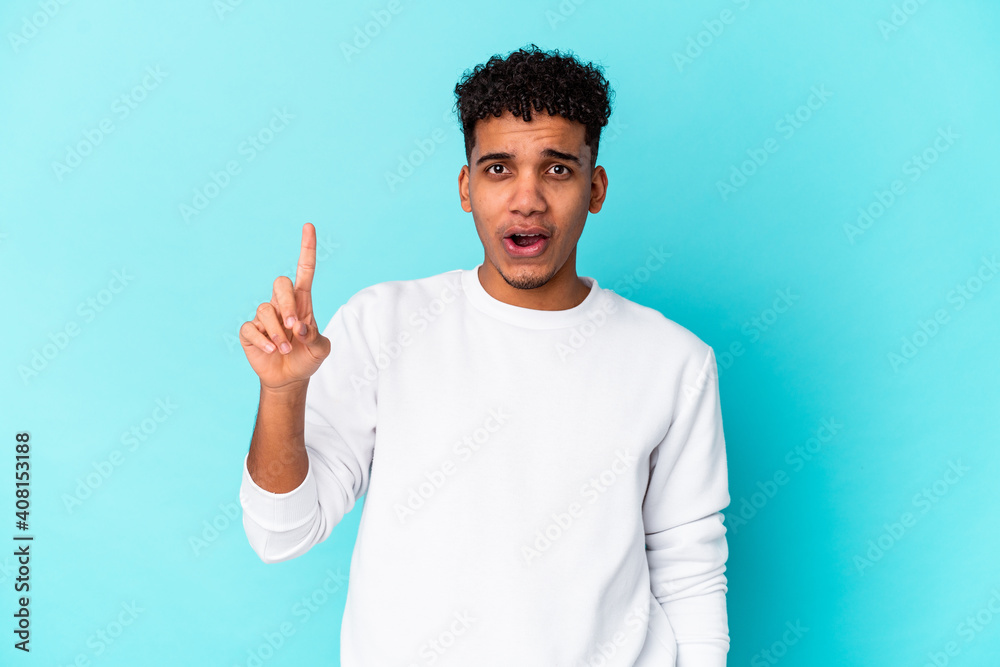 Young african american curly man isolated on blue having some great idea, concept of creativity. Young african american curly man isolated on blue having some great idea, concept of creativity.