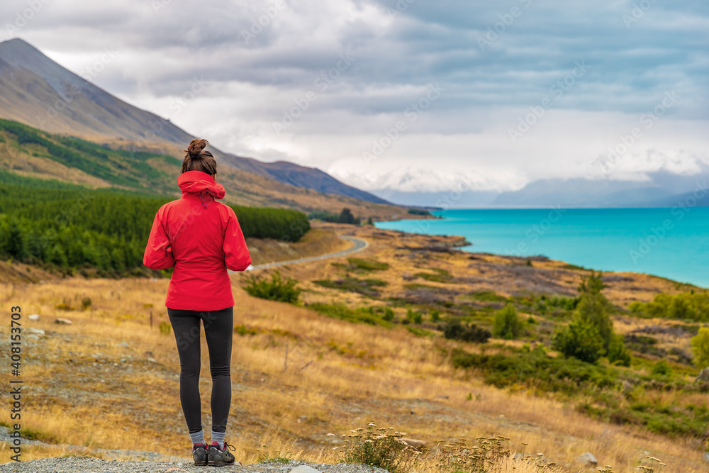 New Zealand travel - Tourist hiker on Road Trip looking at nature view of Lake Pukaki by Aoraki aka Mount Cook at Peters lookout, a famous travel tourist destination. New Zealand travel - Tourist hiker on Road Trip looking at nature view of Lake Pukaki by Aoraki aka Mount Cook at Peters lookout, a famous travel tourist destination.