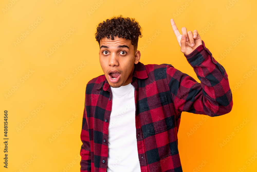 Young african american curly man isolated on purple having some great idea, concept of creativity. Young african american curly man isolated on purple having some great idea, concept of creativity.
