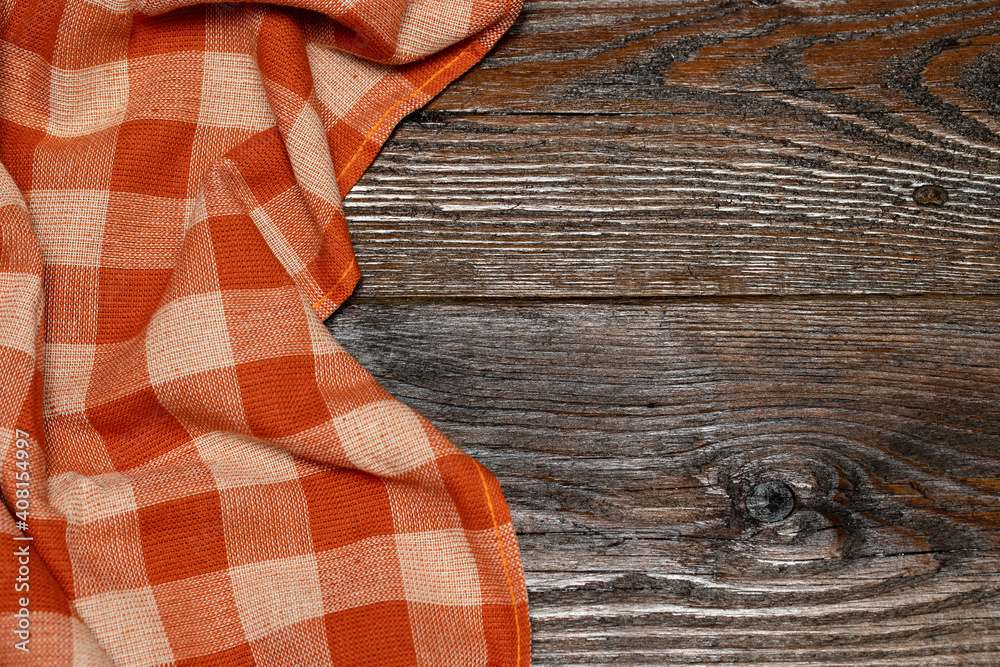 Checkered linen tablecloth on a wooden background