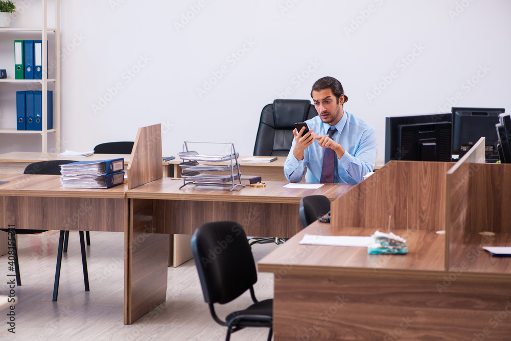 Young male employee working in the office Young male employee working in the office