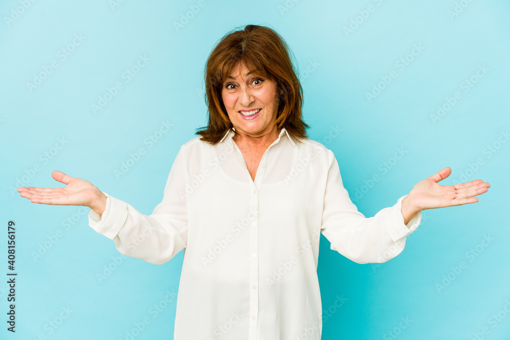 Senior caucasian woman isolated confused and doubtful shrugging shoulders to hold a copy space. Senior caucasian woman isolated confused and doubtful shrugging shoulders to hold a copy space.