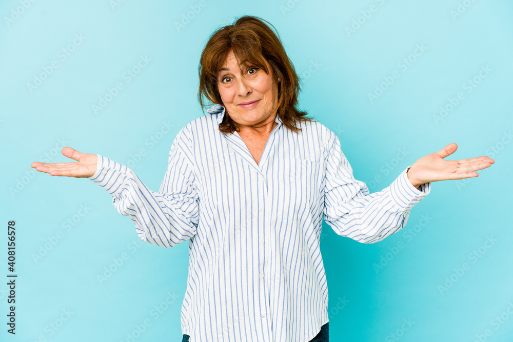 Senior caucasian woman isolated confused and doubtful shrugging shoulders to hold a copy space. Senior caucasian woman isolated confused and doubtful shrugging shoulders to hold a copy space.