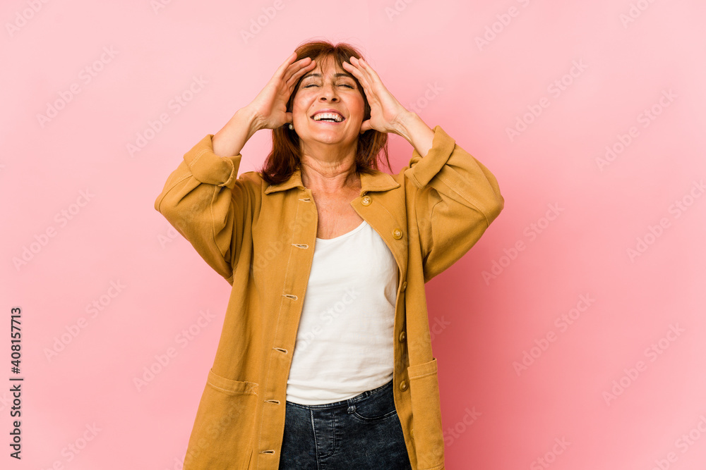 Senior caucasian woman isolated laughs joyfully keeping hands on head. Happiness concept. Senior caucasian woman isolated laughs joyfully keeping hands on head. Happiness concept.