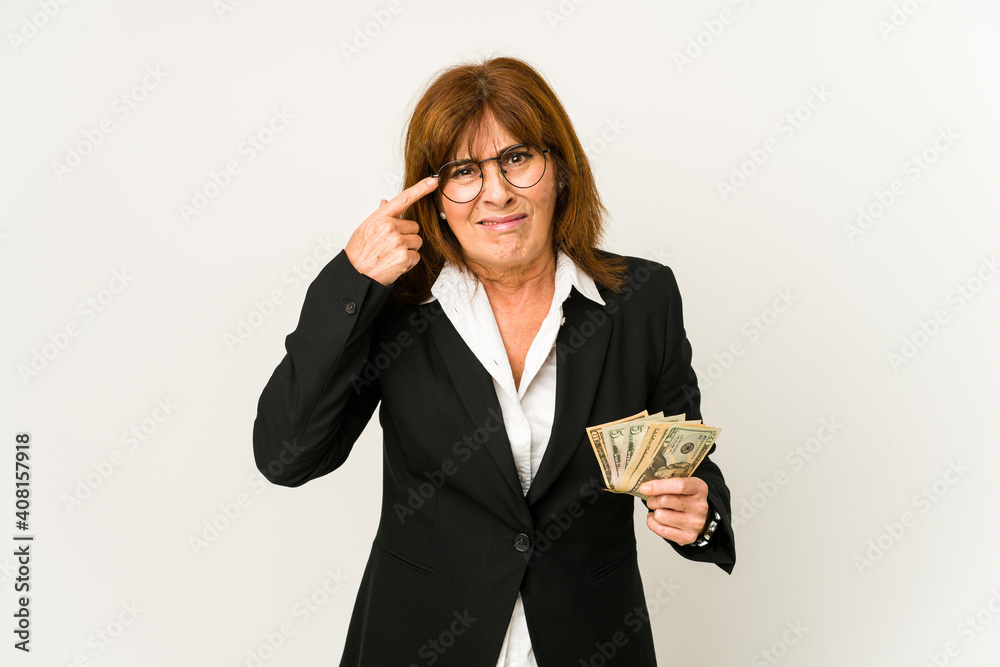 Middle age caucasian business woman holding banknotes isolated showing a disappointment gesture with forefinger. Middle age caucasian business woman holding banknotes isolated showing a disappointment gesture with forefinger.