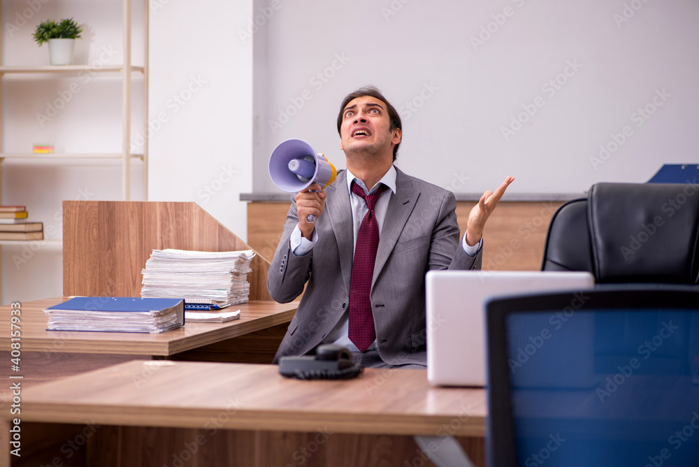 Young businessman employee in bullying concept in the office Young businessman employee in bullying concept in the office