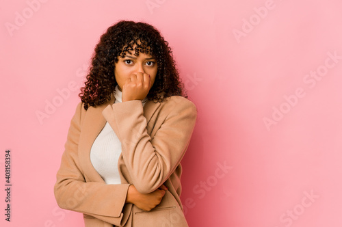 Young african american afro woman isolated biting fingernails, nervous and very anxious.