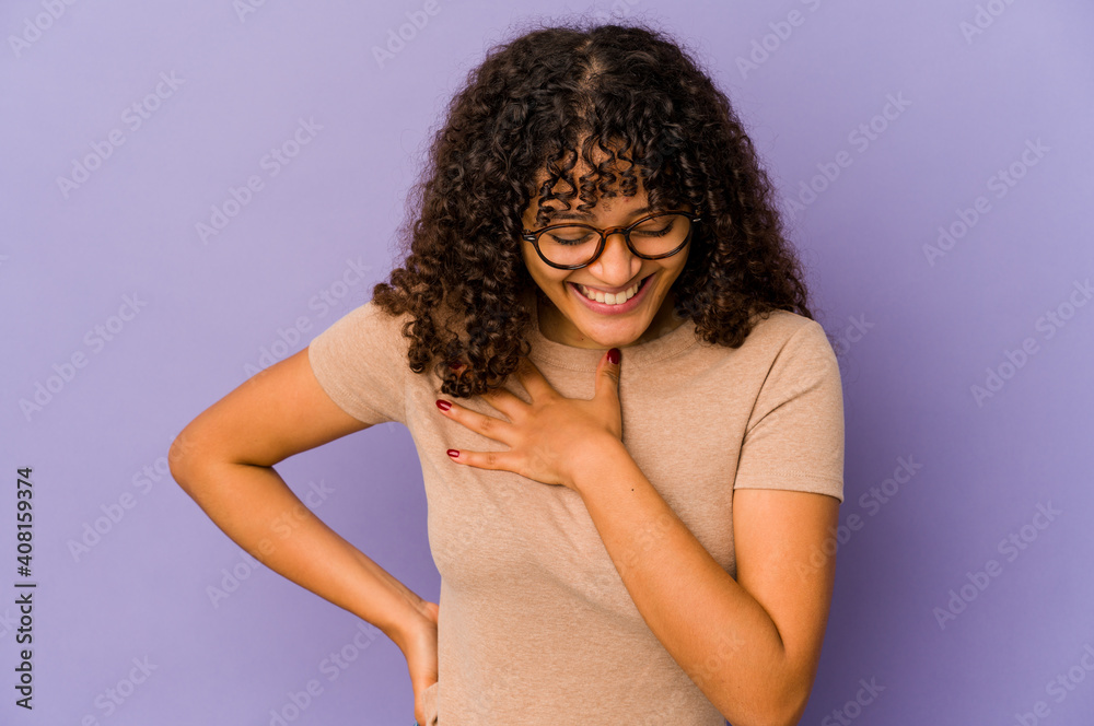 Young african american afro woman isolated laughing keeping hands on heart, concept of happiness. Young african american afro woman isolated laughing keeping hands on heart, concept of happiness.