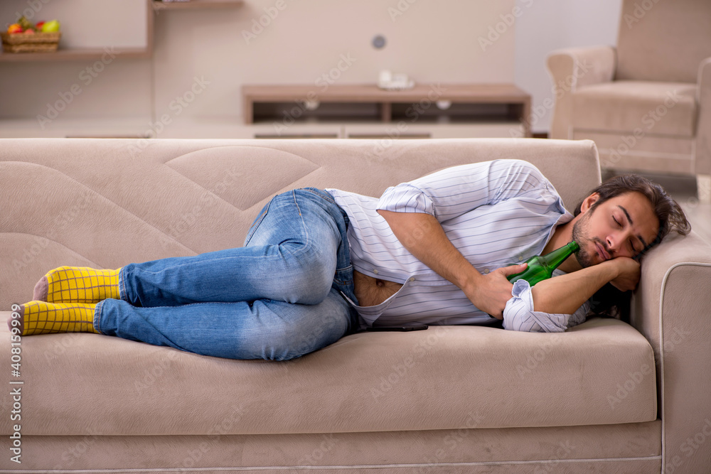 Young man drinking alcohol at home Young man drinking alcohol at home