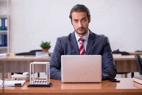 Young man businessman employee sitting in the office