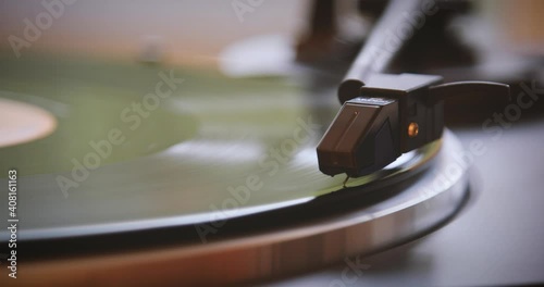 Vintage. The needle goes down on a vintage vinyl record. The vinyl record is spinning. The needle plays on a vintage vinyl record. Old turntable photo