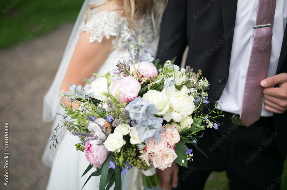 Wedding bouquet in the hands of the bride and groom. Wedding bouquet in the hands of the bride and groom.