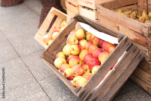 Selling harvest of apples and pears in boxes on the eco market.