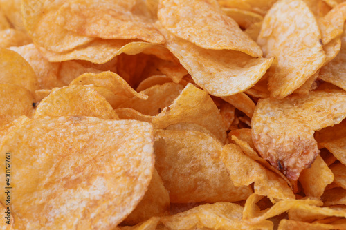 Potato chips or crisps . Close-up of potato chips or crisps. Food background. photo
