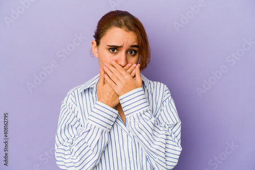 Young arab mixed race woman covering mouth with hands looking worried. © Asier