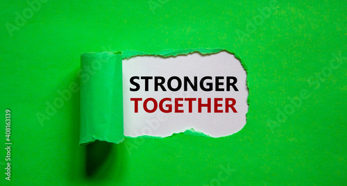 Stronger together symbol. Words Stronger together appearing behind torn green paper. Business, motivational and Stronger together concept. Copy space.