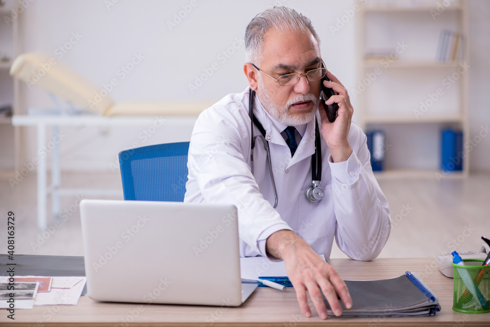 Old male doctor in telemedicine concept Old male doctor in telemedicine concept