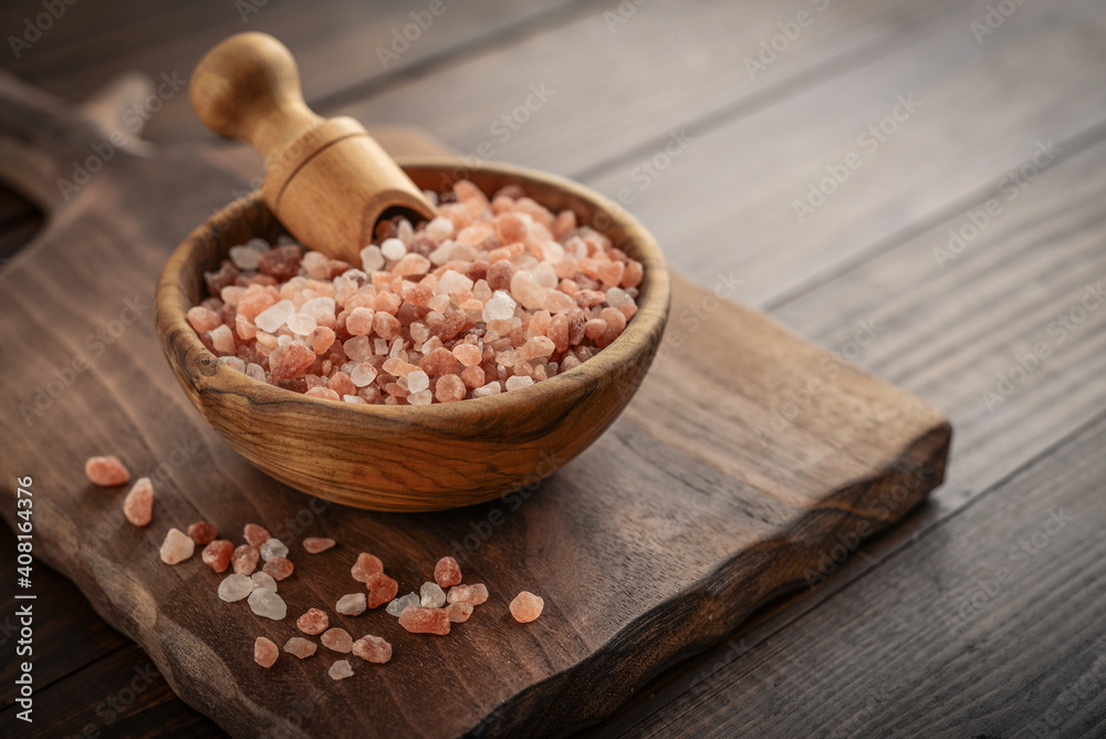 Himalayan pink salt in wooden bowl Himalayan pink salt in wooden bowl