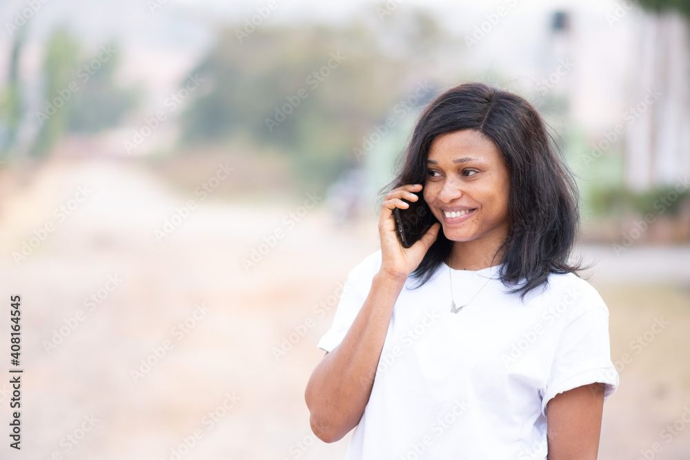 beautiful young african woman smiling while making a phone call outdoor beautiful young african woman smiling while making a phone call outdoor