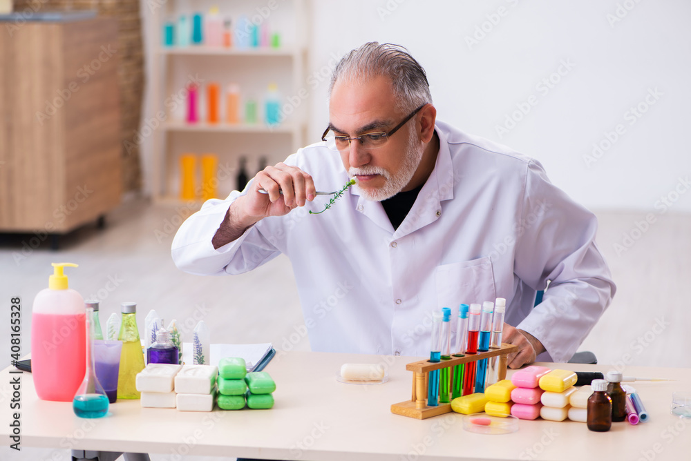 Old male chemist testing soap in the lab Old male chemist testing soap in the lab