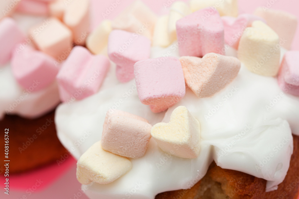 cupcake with hearts from marshmallow on a pink background closeup cupcake with hearts from marshmallow on a pink background closeup